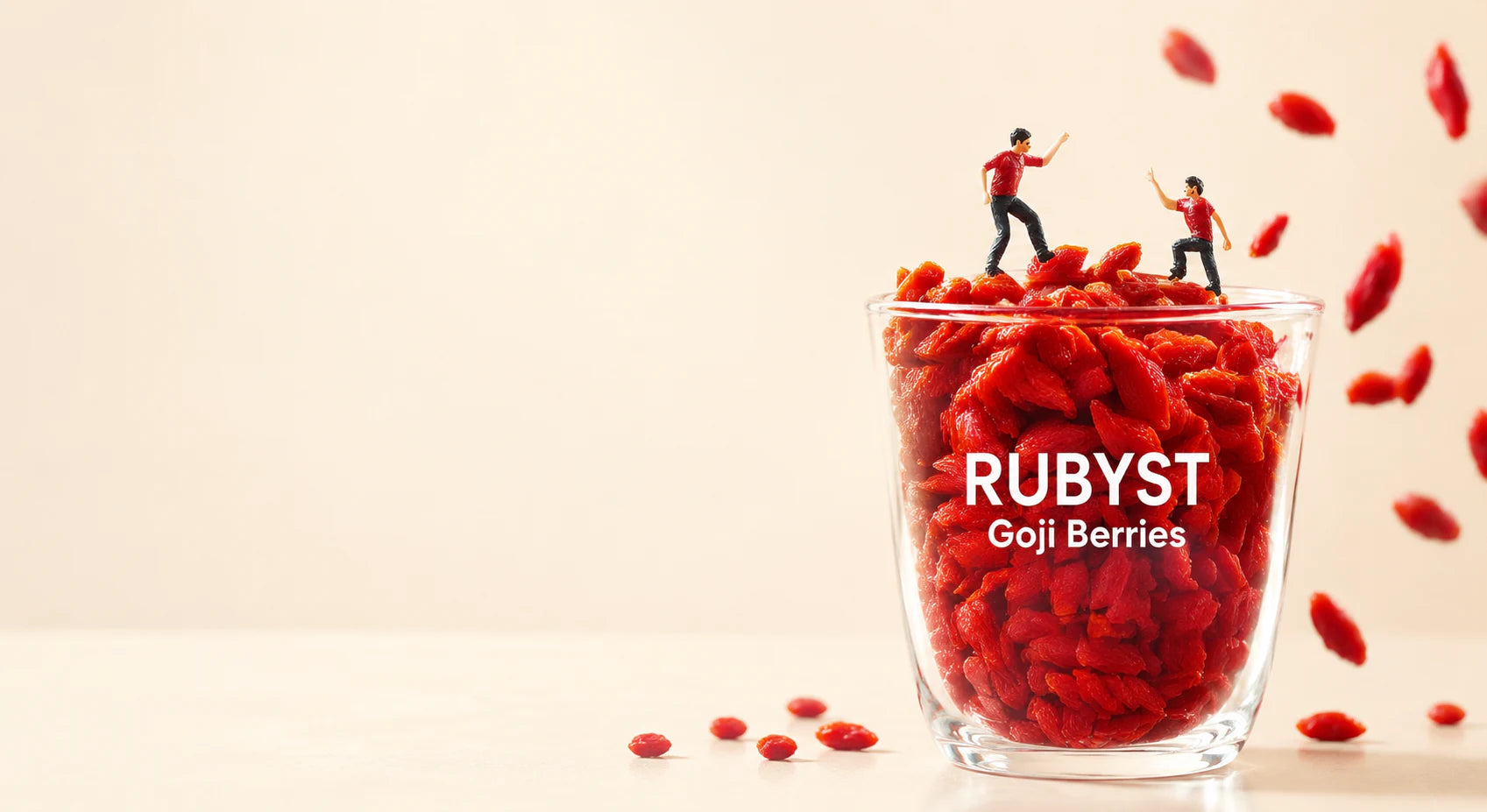 Miniature figures exploring a glass filled with RUBYST goji berries